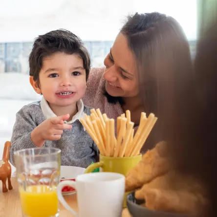 Picture of child eating with care giver